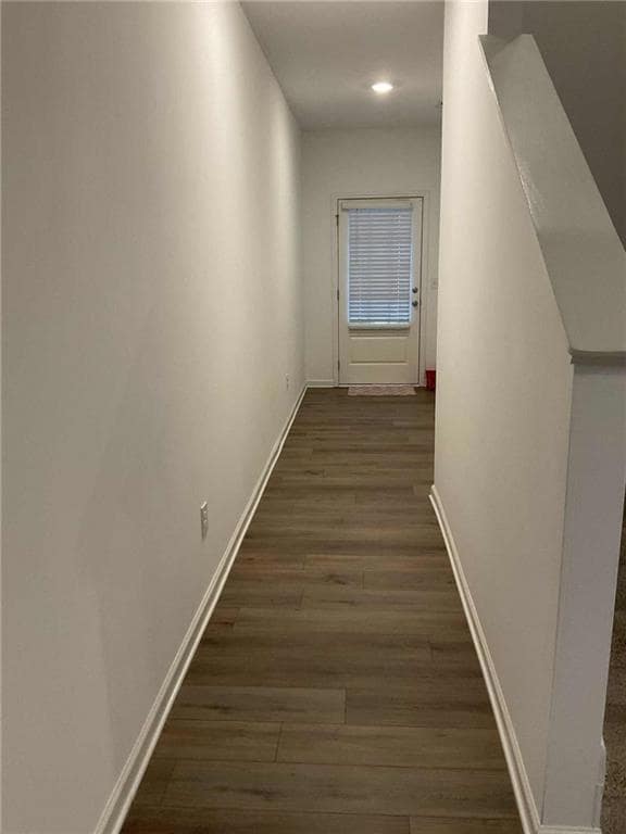 Hall featuring dark wood finished floors, stairway, and recessed lighting