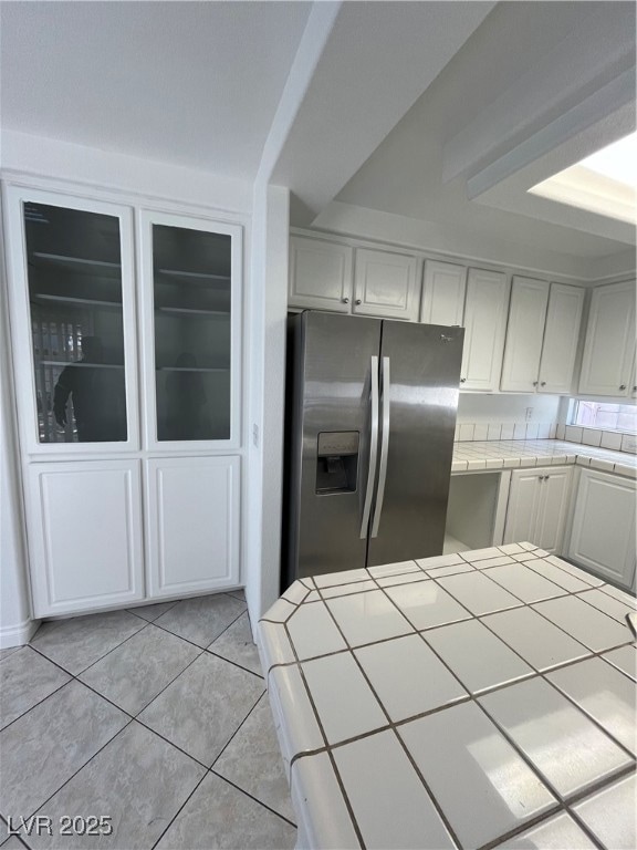 Kitchen with tile countertops, light tile patterne