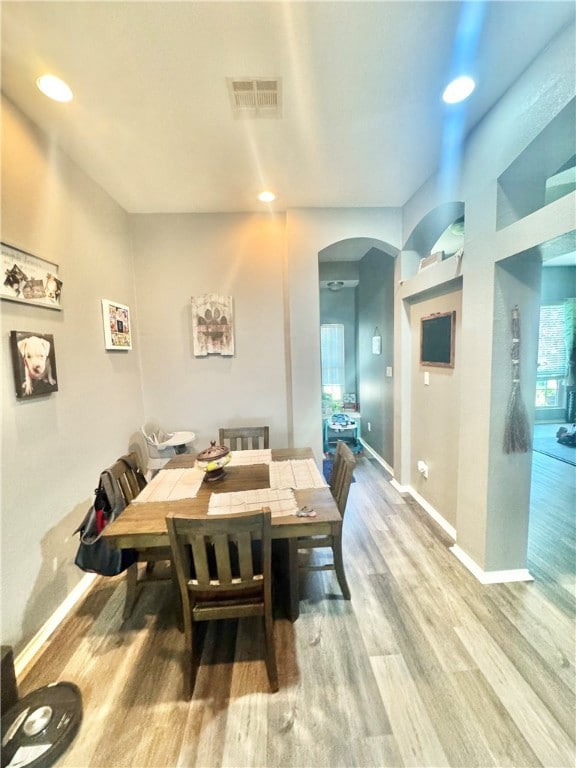 Dining space with arched walkways, wood finished f