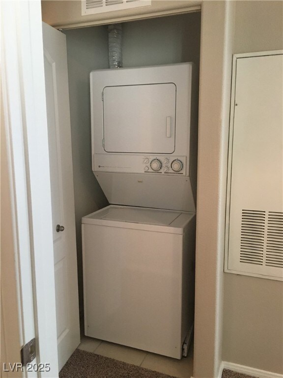 Laundry area featuring estacked washer and dryer a