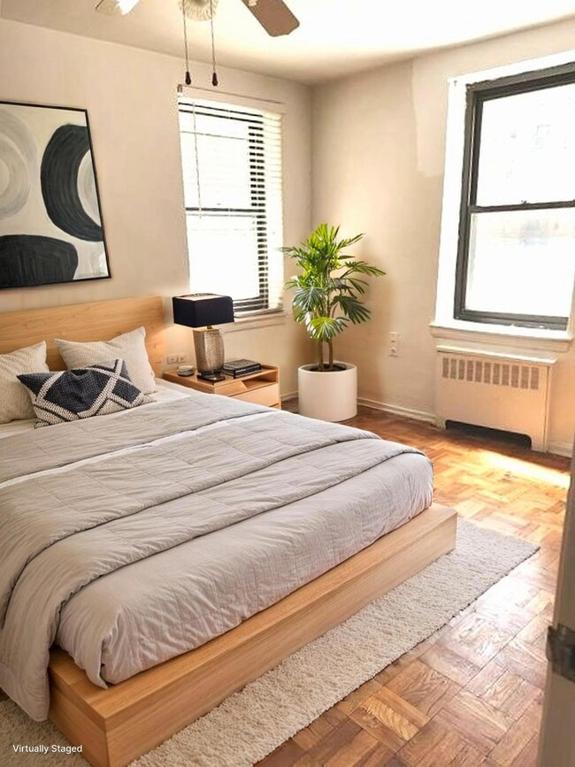 Bedroom featuring radiator heating unit and ceiling fan