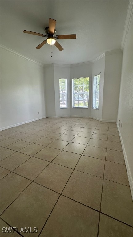 Tiled spare room with crown molding, a ceiling fan