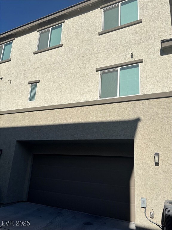 View of property exterior featuring an attached ga