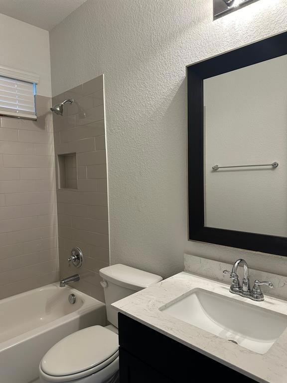 Full bathroom with vanity, shower / tub combinati