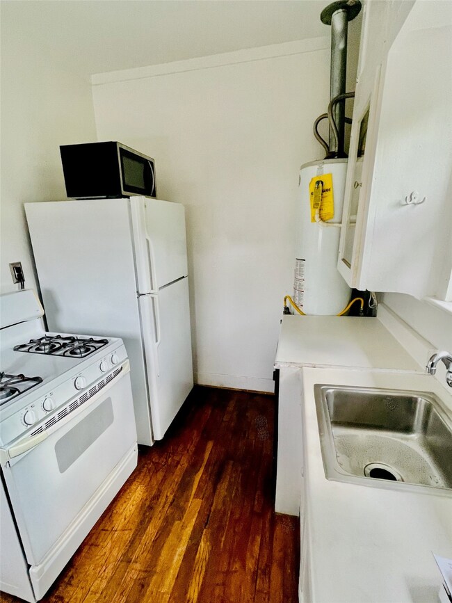 Kitchen includes gas range and microwave.