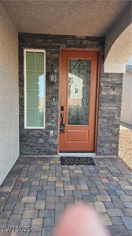 Property entrance featuring stone siding