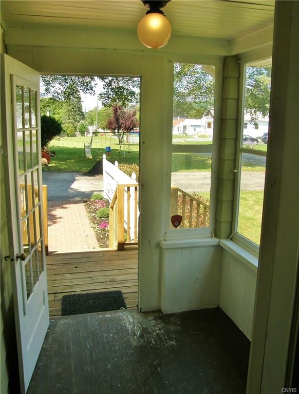 Cheery rear mudroom opens up to the deck, patio, a