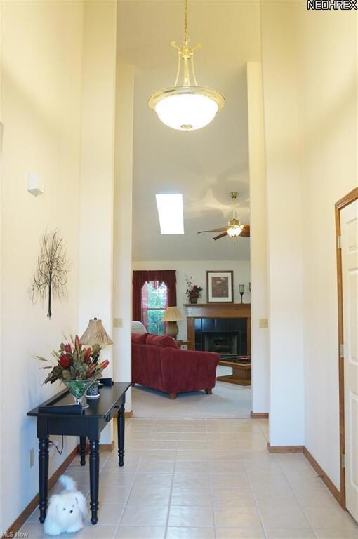 The entry features vaulted ceilings, ceramic tile 