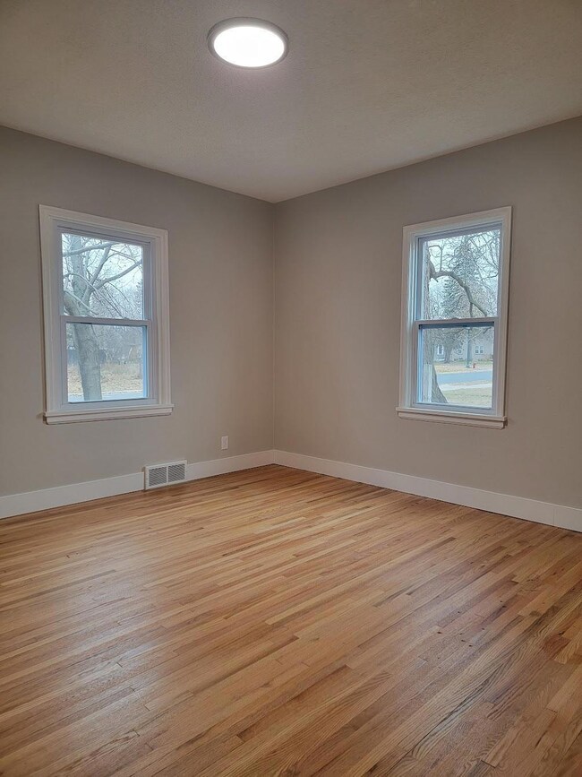 Bedroom 1 has double closets and extra storage space.  BEAUTIFUL freshly refinished original hardwood floors!
