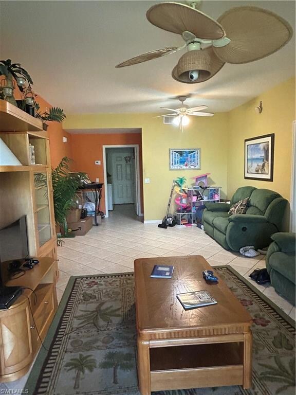 Living area featuring tile patterned floors and ce