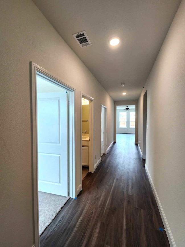 Corridor with sink and dark wood-type flooring