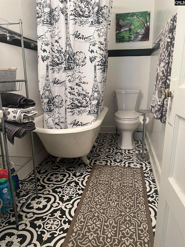 Bathroom. Clawfoot tub, pedastal sink, and cute tiled floors