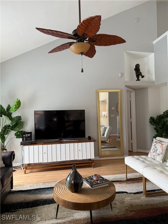 Living room featuring high vaulted ceiling, wood f