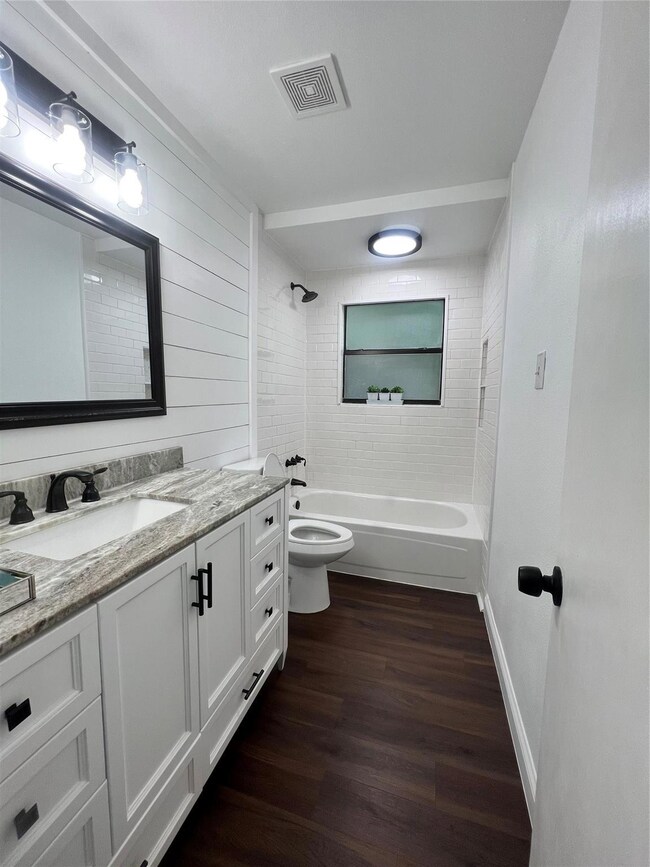 Hall bathroom with granite countertop and large va