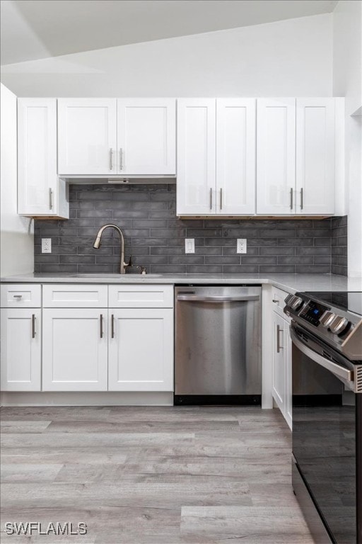 Kitchen featuring white cabinetry, dishwasher, ele
