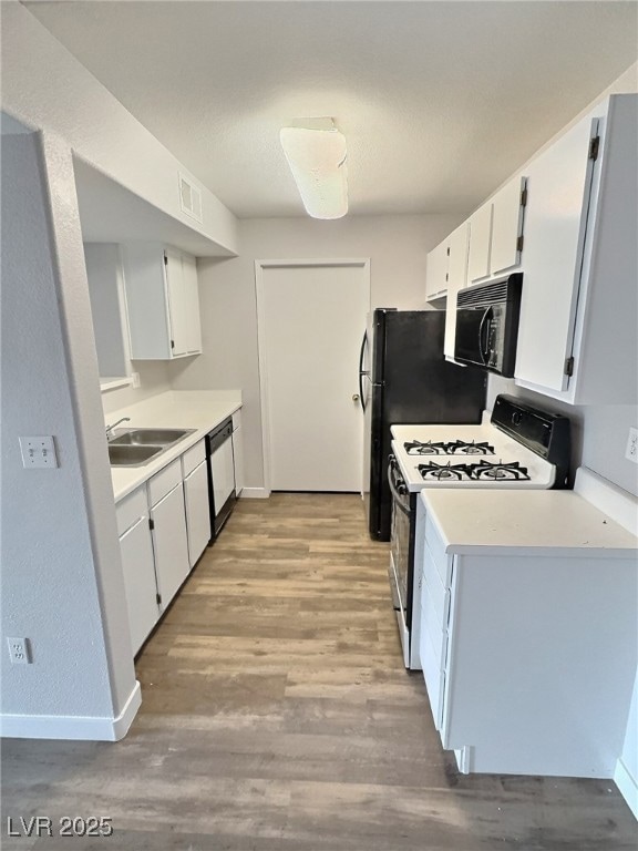 Kitchen featuring a sink, black microwave, gas ran