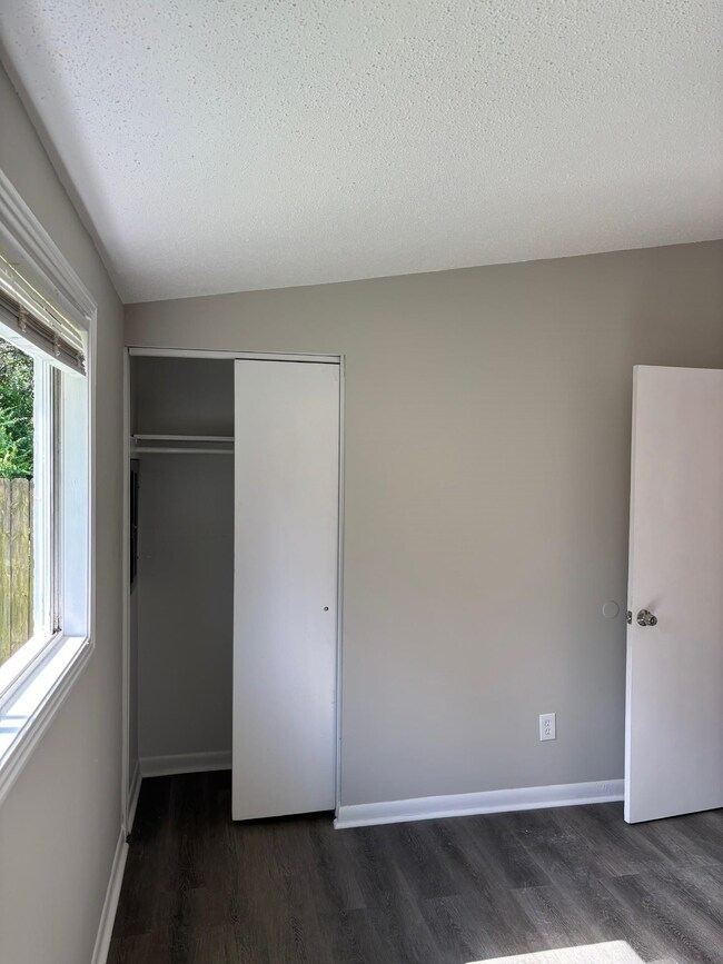 Unfurnished bedroom with a closet, a textured ceil
