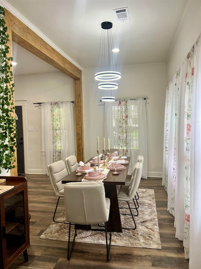 Dining area featuring wood finished floors and bas