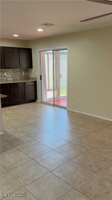 Kitchen with decorative backsplash, light stone co