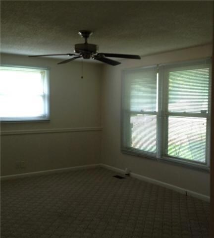 Large living area with ceiling fan. lots of windows.Plenty of room for a Christmas tree right by the window. Cable and phone jacks in room