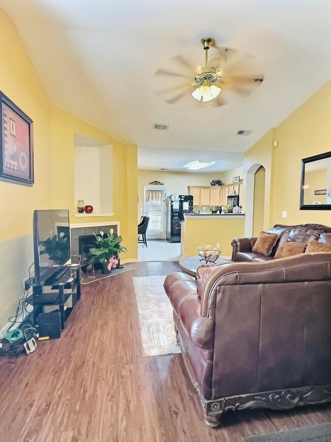 Living room with ceiling fan, hardwood / wood-styl