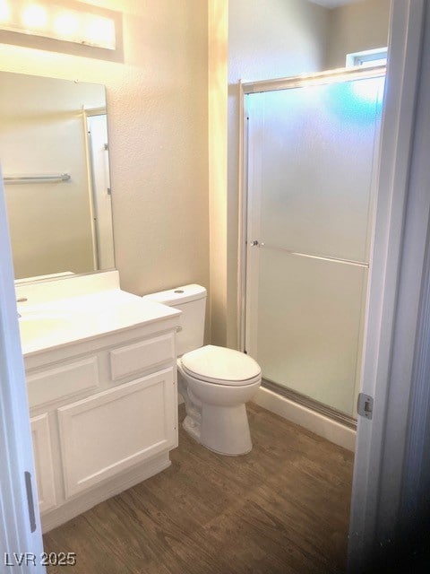 Full bathroom with wood finished floors, vanity, t
