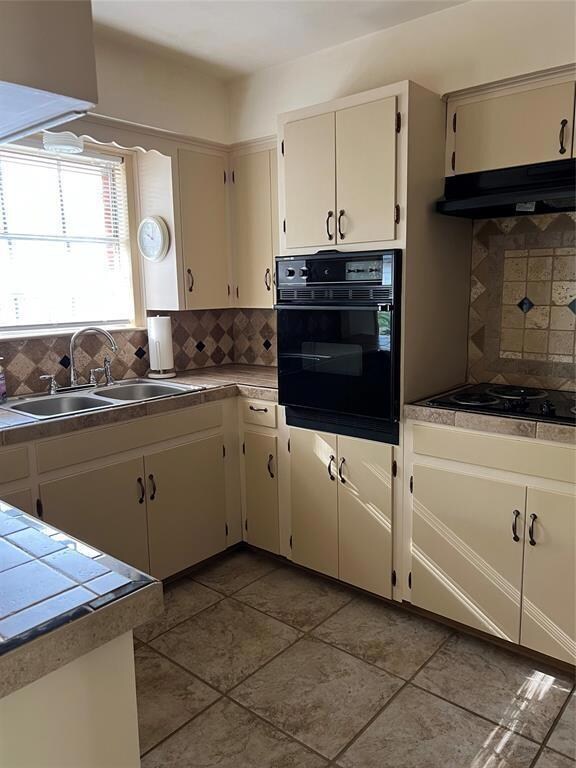 Kitchen with black appliances, under cabinet rang