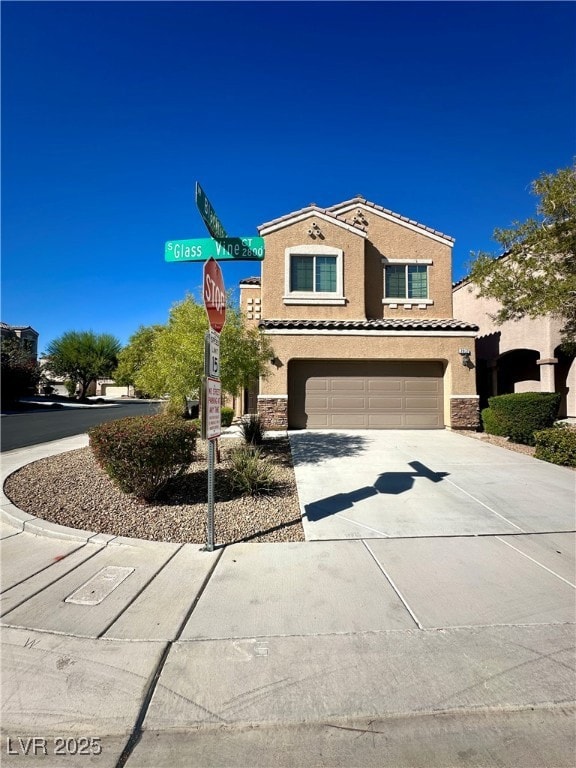 Mediterranean / spanish home with stone siding, driveway, and stucco siding