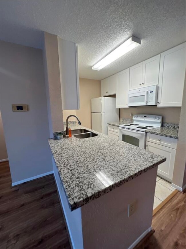 This photo showcases a compact, modern kitchen fea
