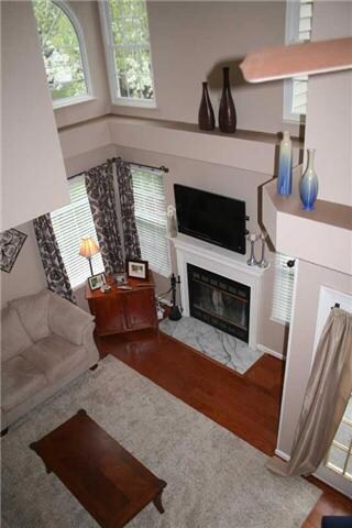 View of two-story living room from balcony above