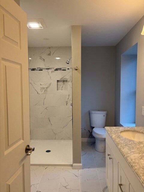 Primary bathroom with walk-in shower and double vanity.
