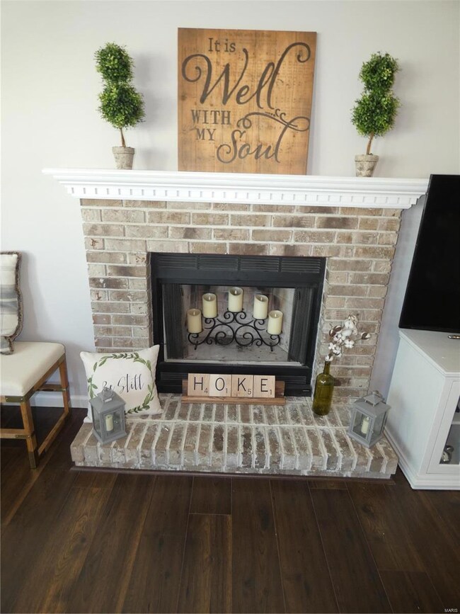 Close up of brick wood burning fireplace with inse