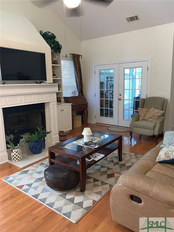 Den with vaulted ceiling with bookcases flanking t