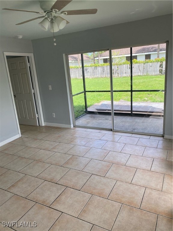 Unfurnished room with a ceiling fan and light tile
