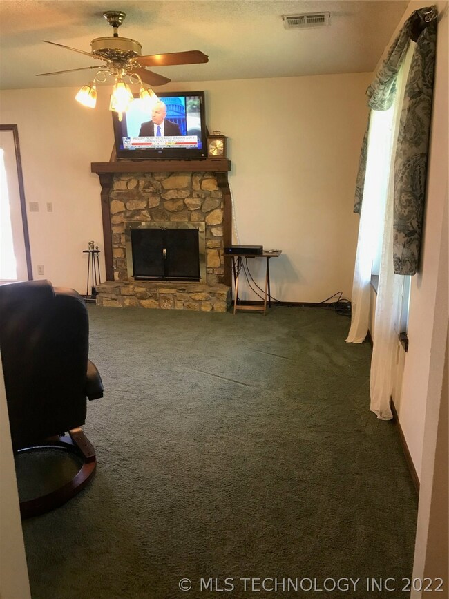 Stone wood burning fireplace. TV and bracket stays
