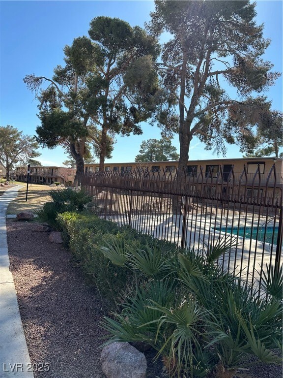 View of swimming pool with a fenced in pool and fe