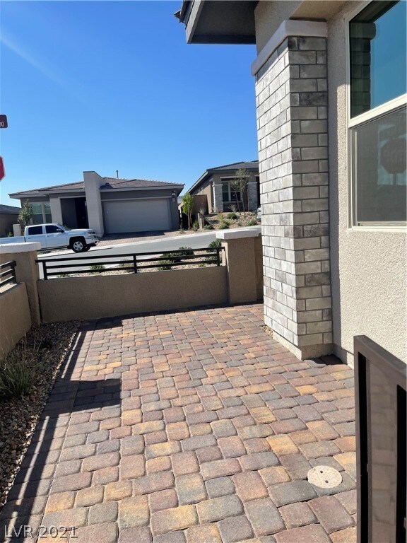 Front patio with metal railings and pavers