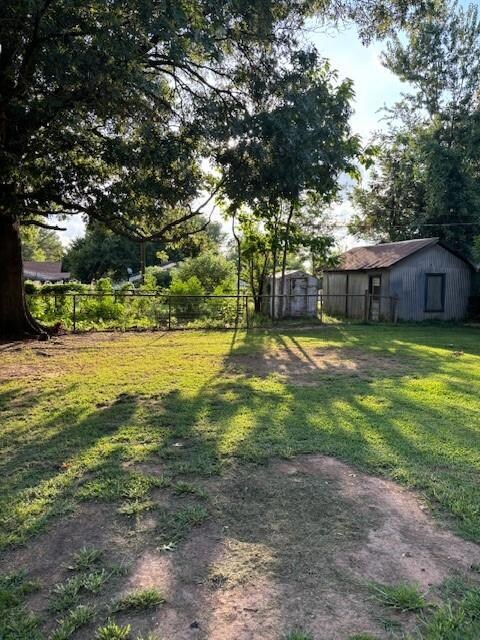View of yard with an outbuilding 7 separately fenc