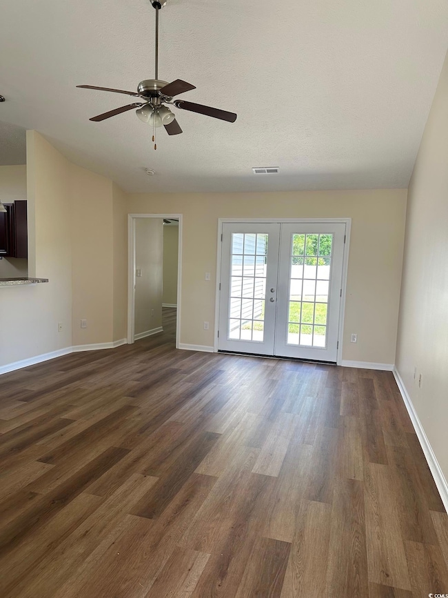 Unfurnished room featuring visible vents, baseboar
