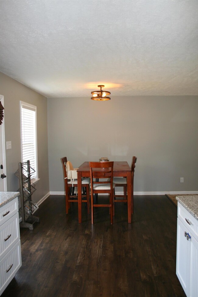 2 new fixtures, new paint in kitchen, lovely floors.Back entrance to deck.