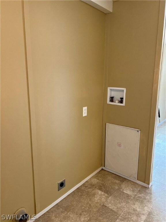 Clothes washing area with hookup for a washing machine, tile flooring, and electric dryer hookup