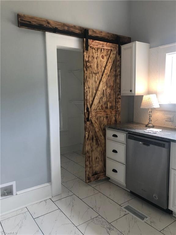 Extra large pantry off the kitchen with custom made scorched barn door