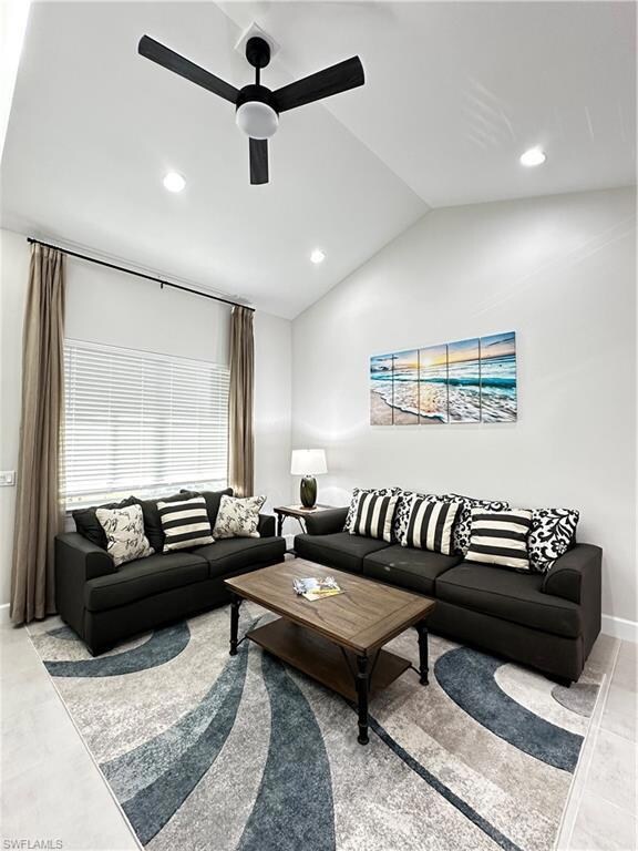 Living room with ceiling fan and vaulted ceiling