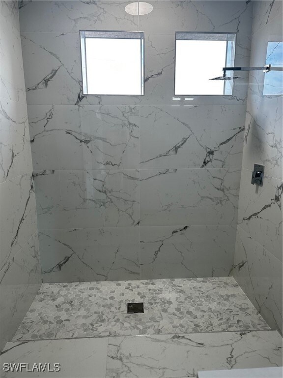 Bathroom featuring tiled shower