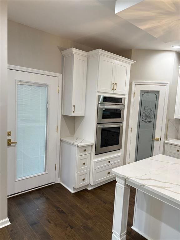 Kitchen with dark wood-type flooring, double oven,