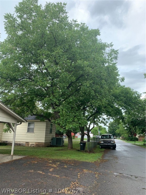 Side of corner lot on Hardy St.  3 car carport/ workshop behind house.