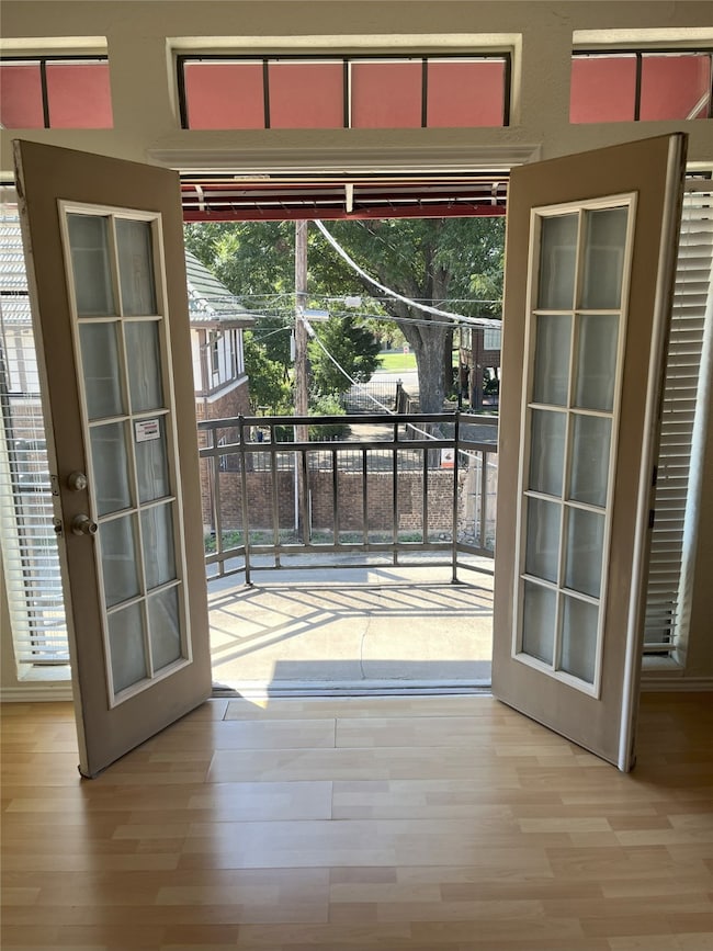 Entryway with wood finished floors and french doors