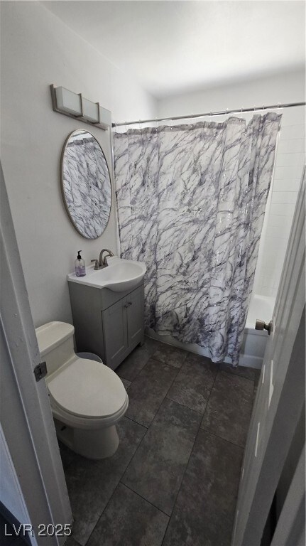 Bathroom with vanity and shower / bath combo with