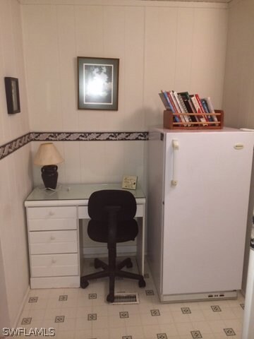 Desk area between kitchen and utility room with 2nd freezer/refrig