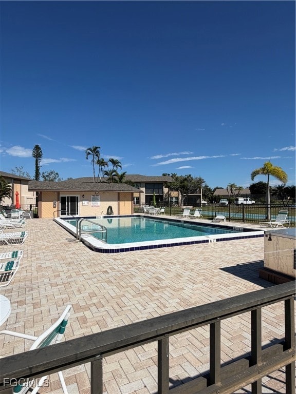 Community pool with a patio